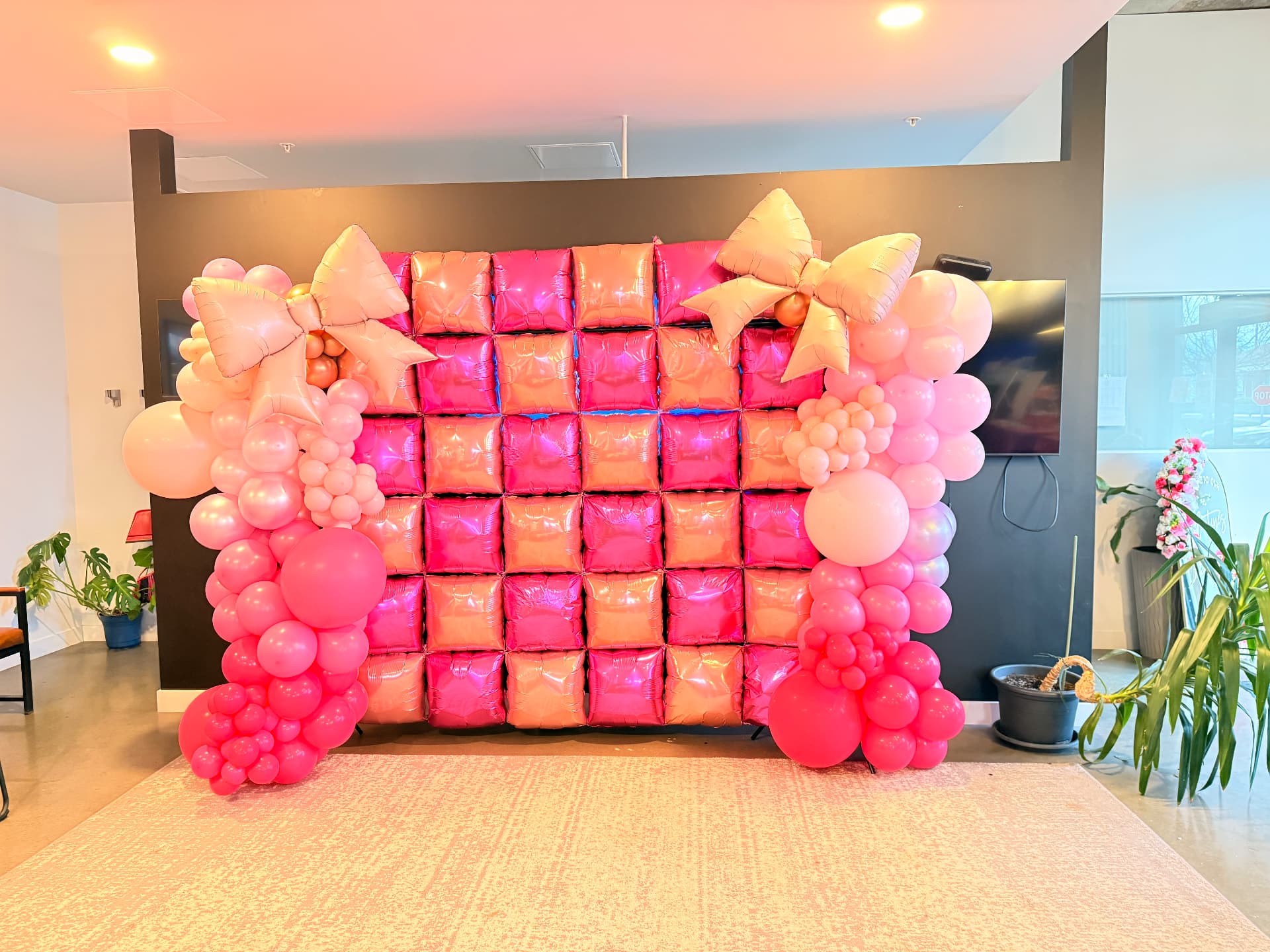 Pink statement balloon wall with bows